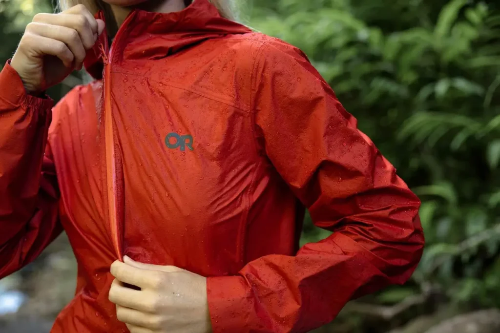 Outdoor Research Helium UL Jacket in red with water droplets on the fabric.